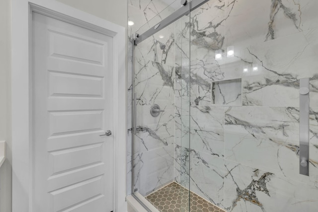 full bath with a marble finish shower