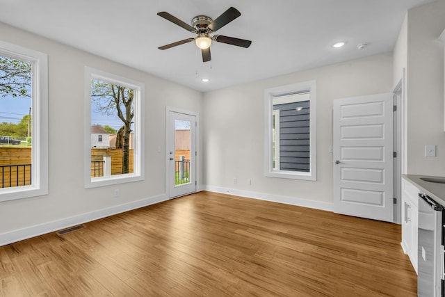 unfurnished room featuring visible vents, baseboards, ceiling fan, recessed lighting, and light wood-style flooring