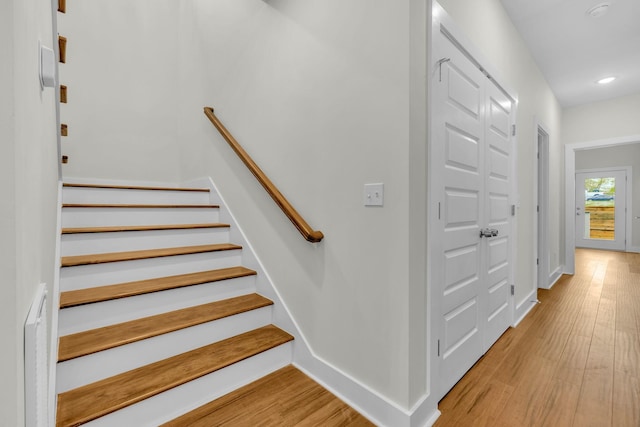 stairs featuring recessed lighting, wood finished floors, and baseboards