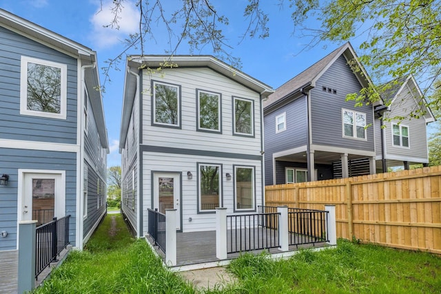 rear view of house with fence