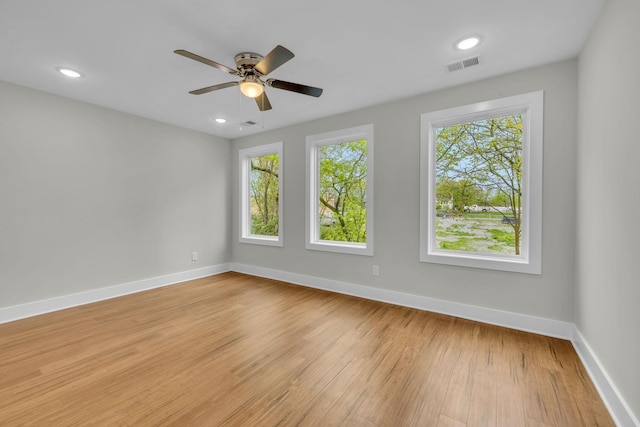 empty room featuring visible vents, a ceiling fan, recessed lighting, light wood-style floors, and baseboards