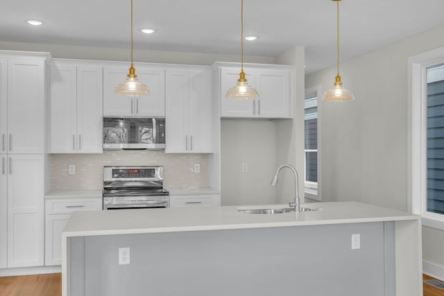 kitchen with a sink, light countertops, white cabinetry, and stainless steel appliances