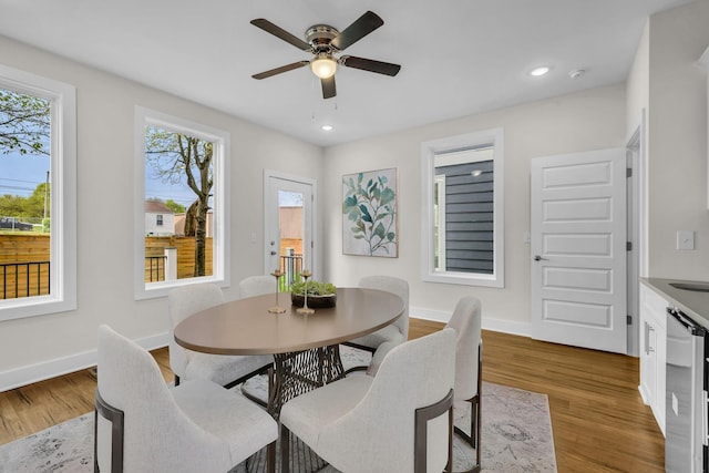 dining area with ceiling fan, baseboards, beverage cooler, and wood finished floors