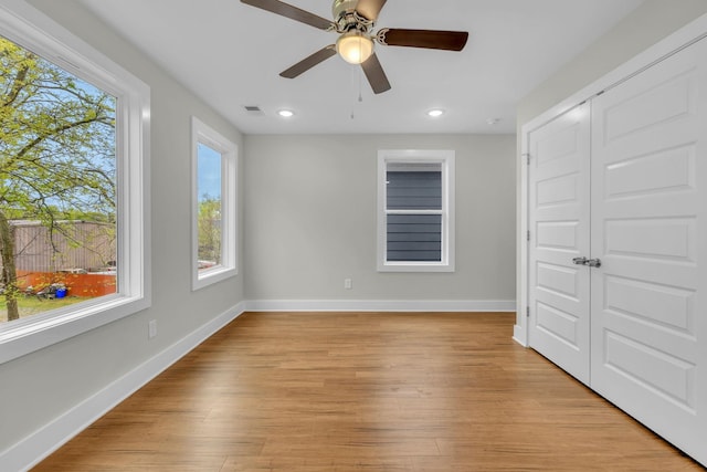 interior space featuring visible vents, baseboards, ceiling fan, recessed lighting, and light wood-style floors