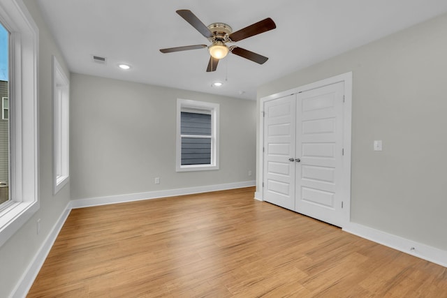 unfurnished bedroom featuring visible vents, light wood-style flooring, recessed lighting, a closet, and baseboards