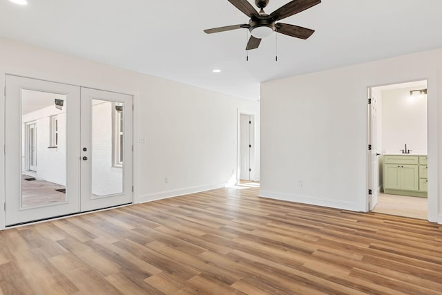 unfurnished bedroom featuring access to exterior, french doors, baseboards, and light wood-style floors