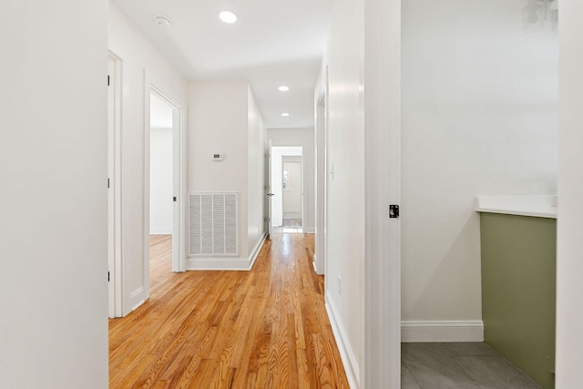 corridor featuring recessed lighting, visible vents, baseboards, and light wood-style floors