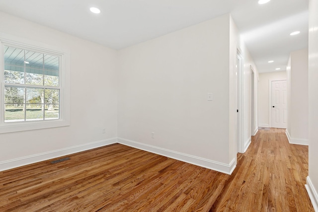 unfurnished room featuring visible vents, recessed lighting, baseboards, and light wood-style floors