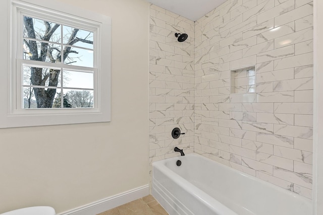 full bathroom featuring bathtub / shower combination, toilet, and baseboards