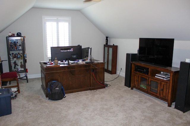 office space featuring light carpet, baseboards, and vaulted ceiling