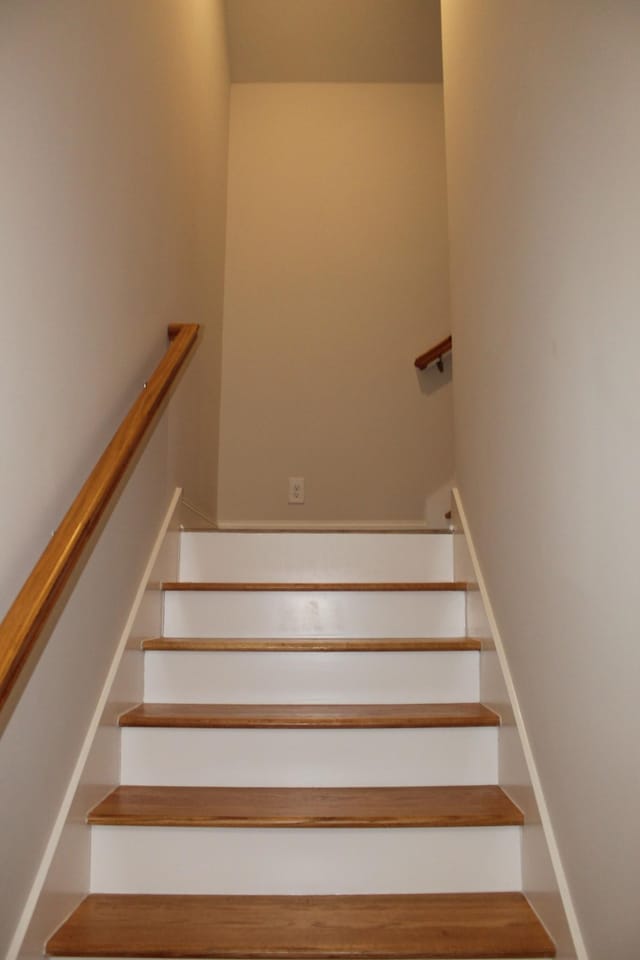 staircase featuring baseboards