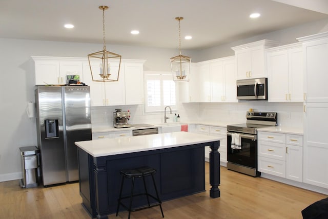 kitchen with decorative backsplash, light wood-style flooring, appliances with stainless steel finishes, and light countertops