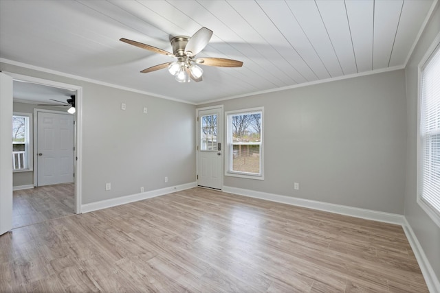 empty room featuring light wood finished floors, baseboards, crown molding, and a ceiling fan