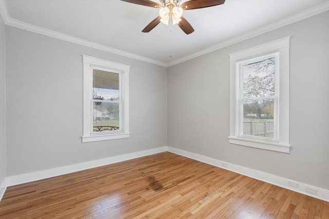 empty room featuring a ceiling fan, baseboards, light wood-style floors, and crown molding