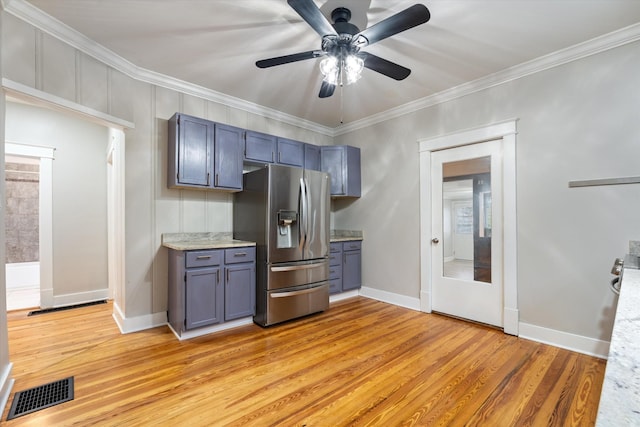 kitchen with visible vents, light wood-style flooring, ornamental molding, ceiling fan, and stainless steel refrigerator with ice dispenser