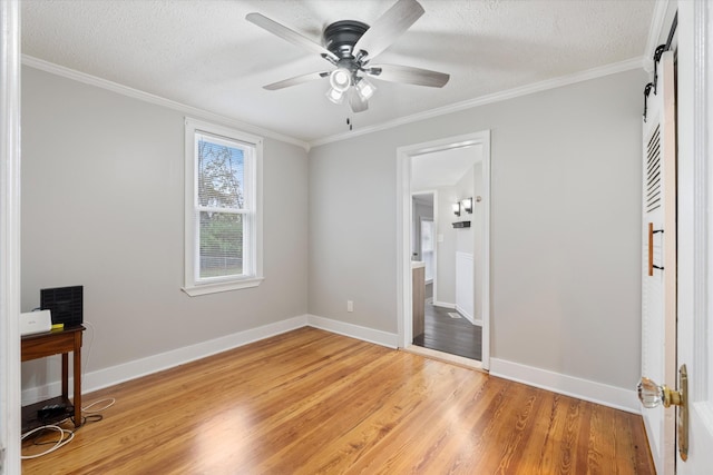 bedroom with crown molding, baseboards, light wood finished floors, and a textured ceiling