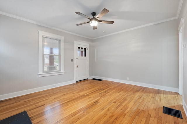 interior space featuring a ceiling fan, visible vents, baseboards, light wood-style flooring, and crown molding