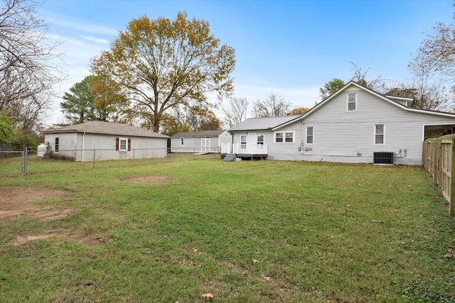 rear view of house with a yard, a fenced backyard, and cooling unit