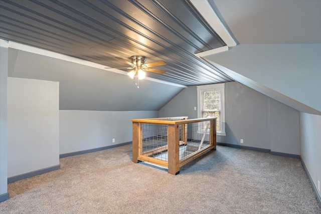 bonus room with carpet flooring, ceiling fan, lofted ceiling, and baseboards