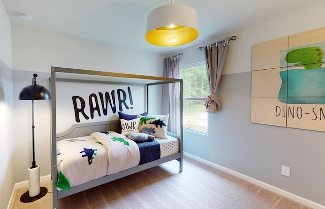 bedroom featuring carpet and baseboards