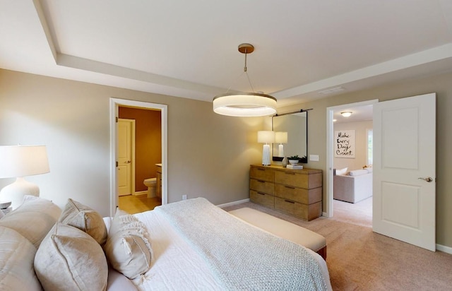 bedroom featuring light carpet, ensuite bathroom, and baseboards