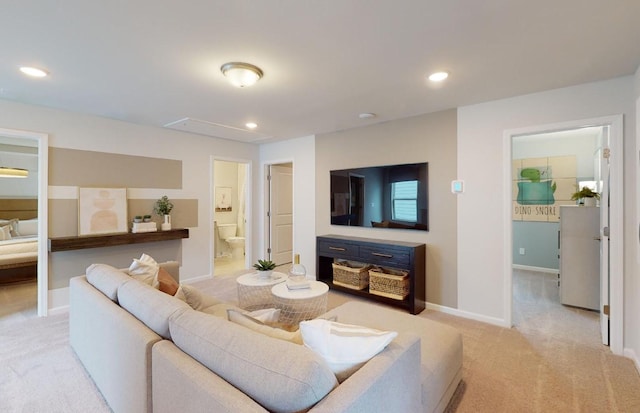 living room featuring light carpet, recessed lighting, attic access, and baseboards