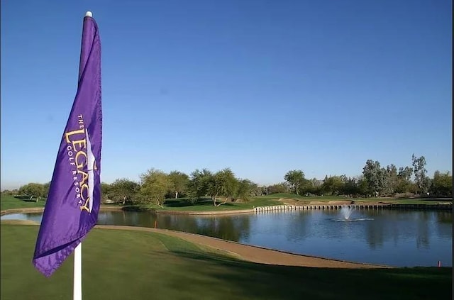 view of property's community featuring golf course view and a water view