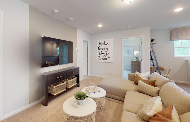 living area with light carpet, recessed lighting, and baseboards