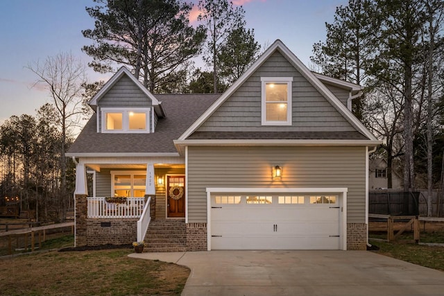 craftsman house featuring a garage, covered porch, concrete driveway, and fence