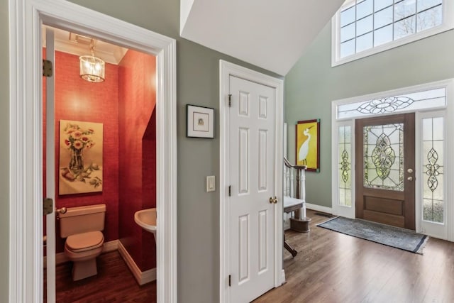 entryway with baseboards, plenty of natural light, and wood finished floors