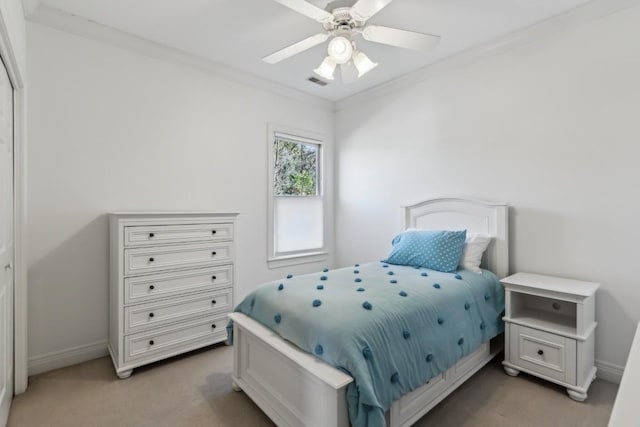 bedroom featuring ornamental molding, light colored carpet, visible vents, and baseboards