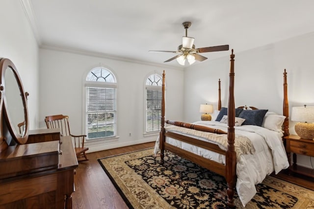 bedroom featuring dark wood-type flooring, a ceiling fan, baseboards, and ornamental molding