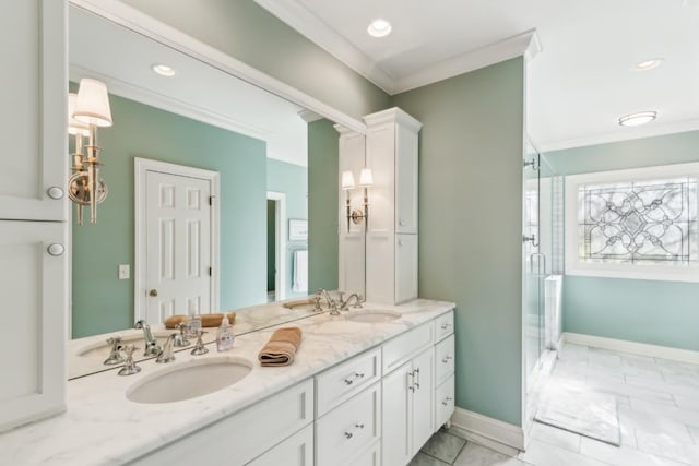 bathroom featuring a shower stall, baseboards, double vanity, ornamental molding, and a sink