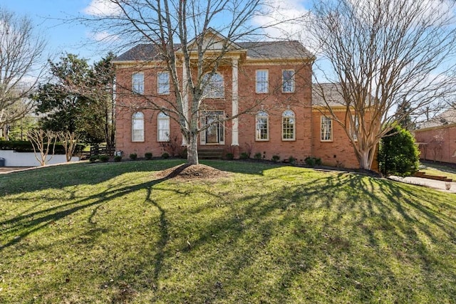 view of front of house featuring a front yard and brick siding