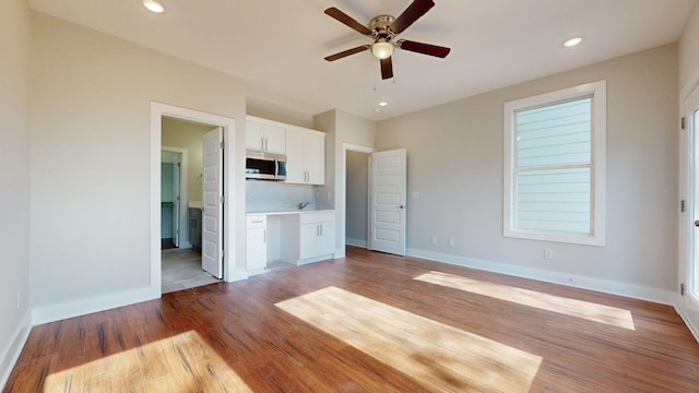 unfurnished living room featuring recessed lighting, light wood-type flooring, baseboards, and ceiling fan