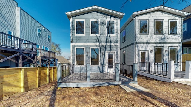 view of front of property with a wooden deck and fence