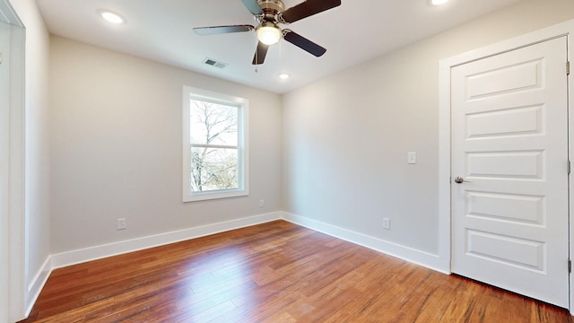 unfurnished room featuring wood finished floors, baseboards, visible vents, recessed lighting, and ceiling fan