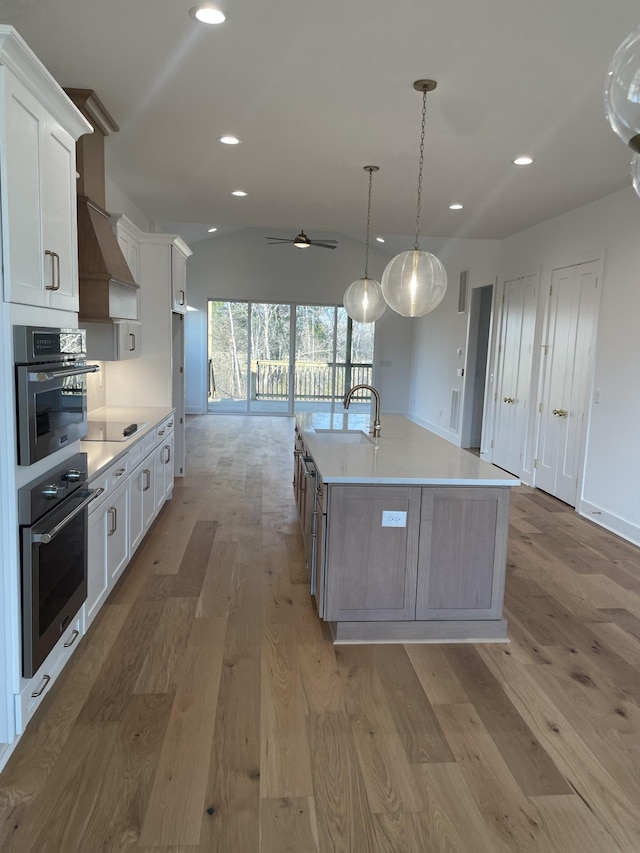 kitchen featuring a sink, light wood-style floors, recessed lighting, and light countertops