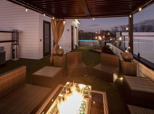 patio terrace at dusk featuring an outdoor hangout area