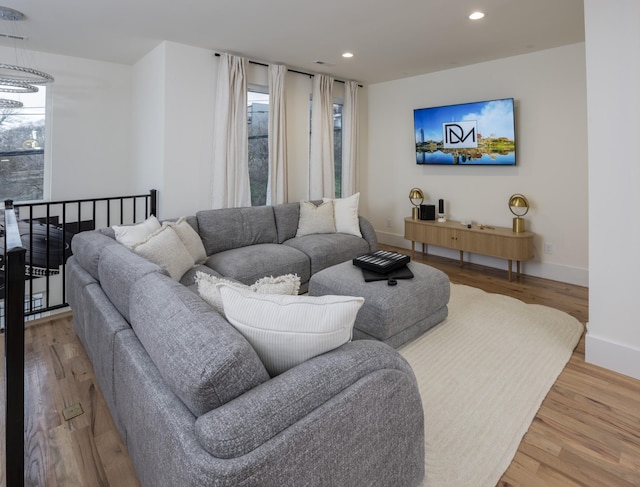 living room featuring a wealth of natural light, wood finished floors, and recessed lighting