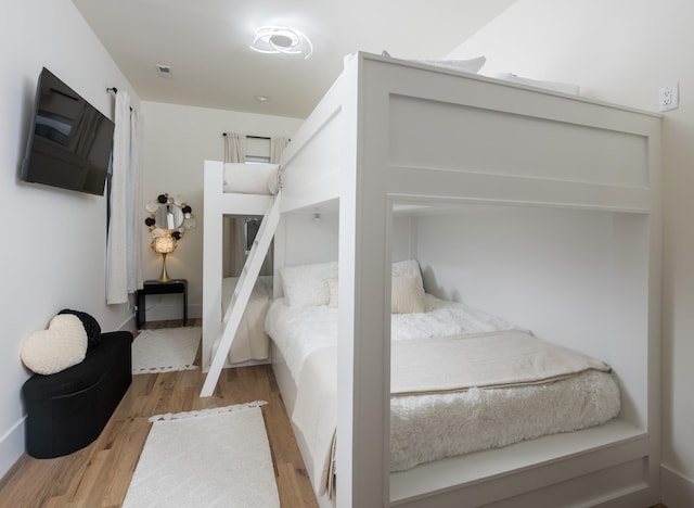 bedroom with wood finished floors