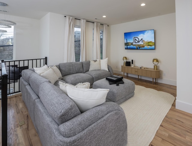 living room featuring plenty of natural light, wood finished floors, and recessed lighting