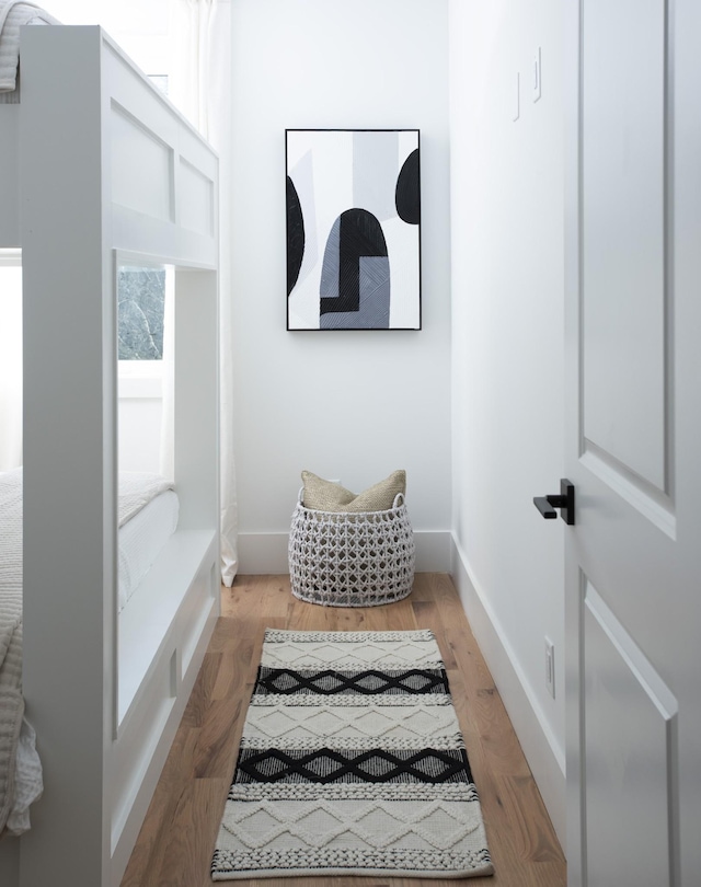 interior space featuring baseboards and wood finished floors