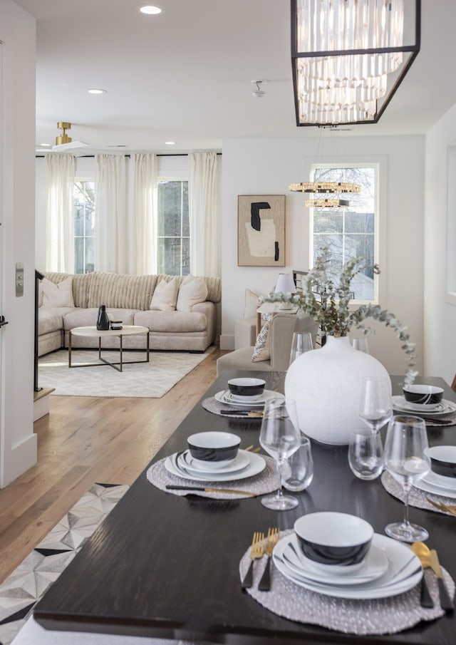 dining space featuring a notable chandelier, recessed lighting, and wood finished floors