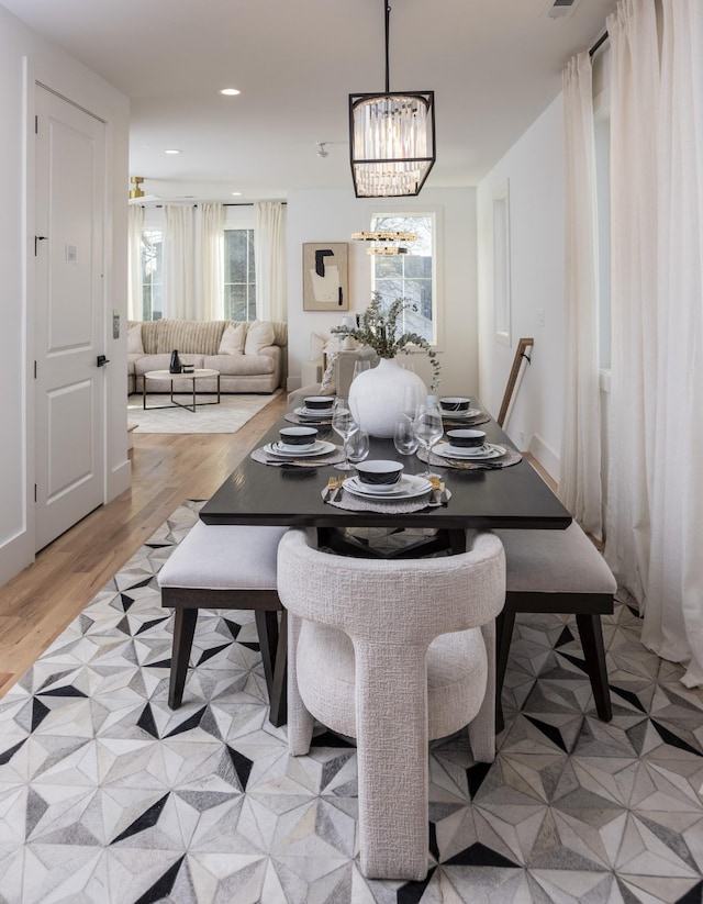 dining room with an inviting chandelier, recessed lighting, light wood-style floors, and visible vents