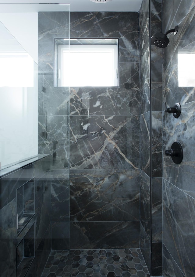 full bath featuring a tile shower