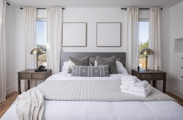 bedroom featuring baseboards and wood finished floors