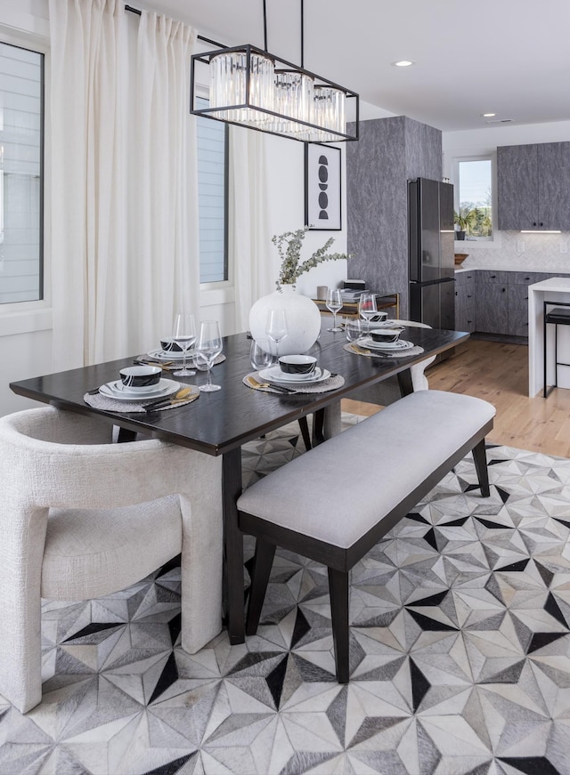 dining space featuring recessed lighting and light wood-style flooring