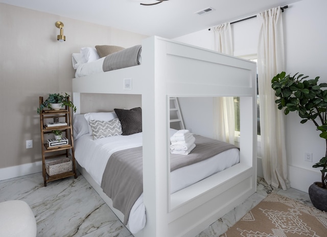 bedroom featuring visible vents and marble finish floor