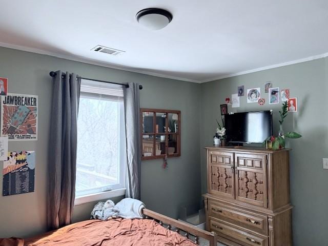 bedroom with visible vents and multiple windows